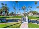 Picturesque community with grassy areas and palm trees, featuring a charming bridge over a tranquil water feature at 2232 W Lindner Ave # 20, Mesa, AZ 85202