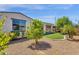 Backyard featuring low-maintenance landscaping, including gravel, plants, and a glimpse of the covered patio at 22472 E Sonoqui Blvd, Queen Creek, AZ 85142