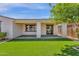 Landscaped backyard featuring a covered patio and a well-maintained artificial grass lawn, offering an inviting space at 22472 E Sonoqui Blvd, Queen Creek, AZ 85142