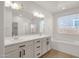 Bright bathroom featuring double sinks, a bathtub, and a separate shower at 22472 E Sonoqui Blvd, Queen Creek, AZ 85142