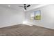 Bedroom with carpet, ceiling fan, and a sunlit view from the window at 22472 E Sonoqui Blvd, Queen Creek, AZ 85142