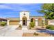 Charming single-story home with a two-car garage, arched entryway, and well-maintained front yard at 22472 E Sonoqui Blvd, Queen Creek, AZ 85142