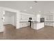 Open-concept kitchen with a large island, white cabinetry, and stainless steel appliances at 22472 E Sonoqui Blvd, Queen Creek, AZ 85142