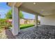Inviting covered patio with brick flooring, offering a charming view of the lush, landscaped backyard at 22472 E Sonoqui Blvd, Queen Creek, AZ 85142