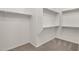 Walk-in closet with carpeting and built-in shelving for optimal organization at 22472 E Sonoqui Blvd, Queen Creek, AZ 85142
