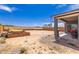 This expansive dirt backyard provides ample space for landscaping and includes a covered patio at 2458 N Abbey Rd, Casa Grande, AZ 85122