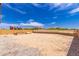 Large backyard, enclosed by a block wall and wire fence, features desert landscaping and a play set at 2458 N Abbey Rd, Casa Grande, AZ 85122