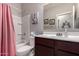 Bathroom featuring a vanity, toilet, and shower over tub with pink curtain at 2458 N Abbey Rd, Casa Grande, AZ 85122
