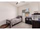 Bedroom with carpeted floors, window, and ceiling fan. Furnished with bed and shelving unit at 2458 N Abbey Rd, Casa Grande, AZ 85122