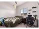 Well-lit bedroom with neutral tones, window and shelves, carpeted floors, and ceiling fan at 2458 N Abbey Rd, Casa Grande, AZ 85122