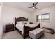 Well-lit main bedroom with a ceiling fan, window, and stylish furnishings at 2458 N Abbey Rd, Casa Grande, AZ 85122