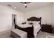 Bright bedroom featuring neutral walls, ceiling fan, and coordinating dark wood furniture at 2458 N Abbey Rd, Casa Grande, AZ 85122