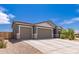 Charming home featuring a three-car garage, neutral paint and desert landscaping at 2458 N Abbey Rd, Casa Grande, AZ 85122