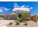 Charming single-story home featuring a three-car garage, neutral paint, and desert landscaping at 2458 N Abbey Rd, Casa Grande, AZ 85122