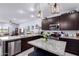Open concept kitchen with stainless steel appliances, granite countertops, and island with pendant lighting at 2458 N Abbey Rd, Casa Grande, AZ 85122