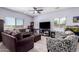 Cozy living room with tile floors, a ceiling fan, and natural light at 2458 N Abbey Rd, Casa Grande, AZ 85122