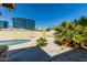 Private backyard oasis featuring a sparkling pool, lush greenery, and mature palm trees with city views at 2544 E Elm St, Phoenix, AZ 85016