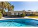 Backyard featuring a refreshing pool, a well-maintained lawn, and mature trees providing privacy and shade at 2544 E Elm St, Phoenix, AZ 85016