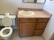 Bathroom with wooden vanity and neutral-colored sink at 2544 E Elm St, Phoenix, AZ 85016