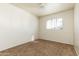 Bedroom with neutral walls, carpet, and a window for natural light at 2544 E Elm St, Phoenix, AZ 85016