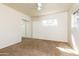 Bright bedroom featuring neutral walls, carpet, and ceiling fan at 2544 E Elm St, Phoenix, AZ 85016