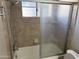 Tile shower and bath with glass doors at 2544 E Elm St, Phoenix, AZ 85016