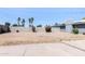 Back yard with tall block wall, some bushes, and a large concrete patio at 2715 E Edgemont Ave, Phoenix, AZ 85008