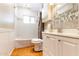 Bathroom featuring tile shower, white cabinetry, and modern fixtures at 2715 E Edgemont Ave, Phoenix, AZ 85008