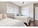 Bright bedroom with two beds, dark wood floor and closet at 2715 E Edgemont Ave, Phoenix, AZ 85008