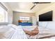 Bedroom with large windows, ceiling fan, and mounted television at 2715 E Edgemont Ave, Phoenix, AZ 85008