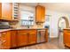 Kitchen with wooden cabinets, granite countertops, stainless steel appliances, and wine rack at 2715 E Edgemont Ave, Phoenix, AZ 85008