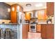 Eat-in kitchen featuring wooden cabinets, stainless steel appliances and stone accented bar at 2715 E Edgemont Ave, Phoenix, AZ 85008