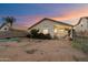 Backyard view of the home, featuring a covered patio, shrubs, and a block wall at 3015 S Woodruff Dr, Mesa, AZ 85212