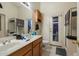Well-lit bathroom featuring double sinks with wood cabinets, a toilet, and a shower at 3015 S Woodruff Dr, Mesa, AZ 85212