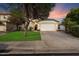 Charming single-Gathering home featuring a well-maintained lawn and attached two-car garage at 3015 S Woodruff Dr, Mesa, AZ 85212