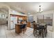 Well-lit kitchen with tile flooring, a modern island, stainless appliances, and casual dining area at 3015 S Woodruff Dr, Mesa, AZ 85212