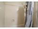 Shower with white tiles and a shower curtain at 3015 S Woodruff Dr, Mesa, AZ 85212