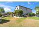 Expansive backyard featuring lush lawn, mature trees, and trampoline, perfect for outdoor activities and relaxation at 345 N Scott Dr, Chandler, AZ 85225