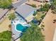 Inviting backyard featuring a sparkling pool, lounge area, mature landscaping, and a trampoline for recreation at 345 N Scott Dr, Chandler, AZ 85225
