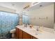 Bathroom featuring a double sink vanity, large mirror, and floral shower curtain at 345 N Scott Dr, Chandler, AZ 85225