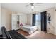 Neutral bedroom with a full sized bed, white bookshelf, dark curtains and an electric ceiling fan at 345 N Scott Dr, Chandler, AZ 85225