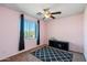 Bedroom with a pink wall, ceiling fan, dark curtains and a black and white rug at 345 N Scott Dr, Chandler, AZ 85225