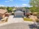 Beautifully landscaped modern home featuring a stone-accented facade, well-manicured lawn, and a spacious driveway at 345 N Scott Dr, Chandler, AZ 85225