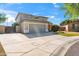 Charming two-story home with a gray garage door, stone accents, and well-maintained landscaping at 345 N Scott Dr, Chandler, AZ 85225
