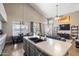 Open kitchen with large island, seating and stainless steel dishwasher, sink and faucet at 345 N Scott Dr, Chandler, AZ 85225