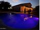 Inviting backyard pool illuminated at night, perfect for relaxation and entertaining with its tranquil ambiance at 345 N Scott Dr, Chandler, AZ 85225