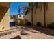 Paver backyard with palm tree and green bushes near a stucco home at 3530 S Bandit Rd, Gilbert, AZ 85297