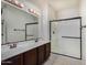 Bright bathroom featuring a double sink vanity with a walk-in shower and glass enclosure at 3530 S Bandit Rd, Gilbert, AZ 85297