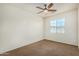 Bedroom with neutral walls, carpet flooring, ceiling fan, and natural light from the window at 3530 S Bandit Rd, Gilbert, AZ 85297