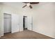 Bedroom featuring carpet flooring, neutral walls, ceiling fan, and closet with double doors at 3530 S Bandit Rd, Gilbert, AZ 85297